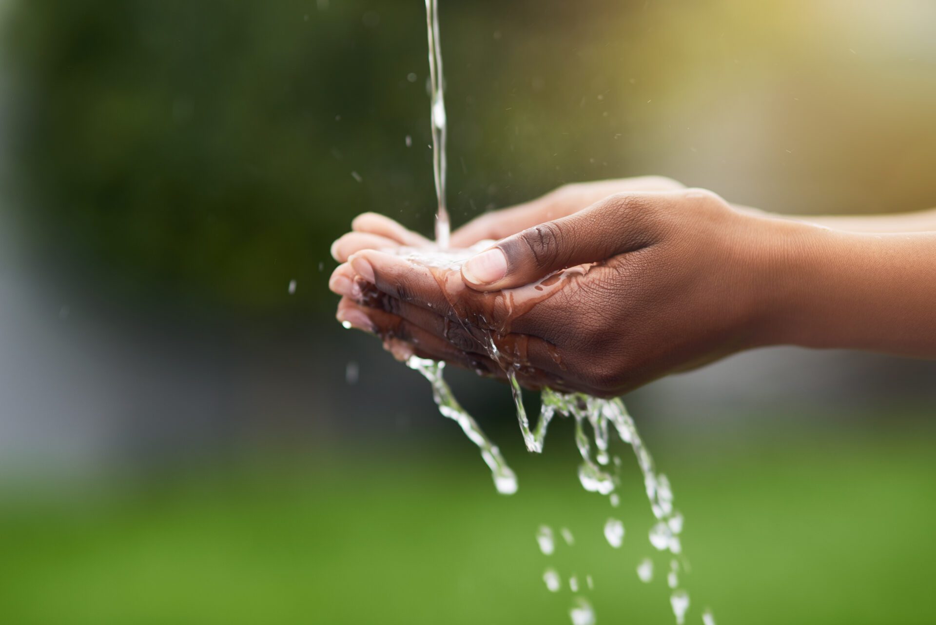 Water...the source of all life. Cropped shot of a woman washing her hands outdoors. Water...the source of all life. Cropped shot of a woman washing her hands outdoors.